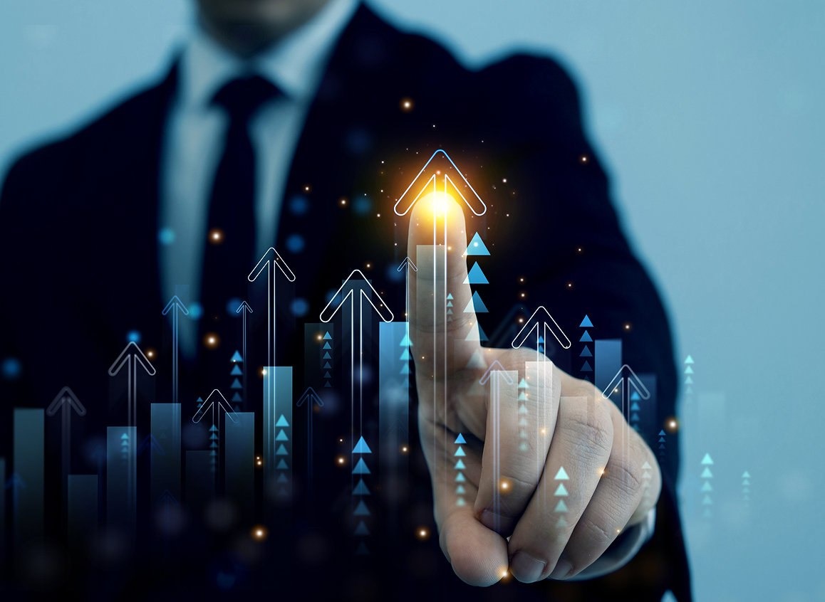 Businessman pointing at glowing upward arrow