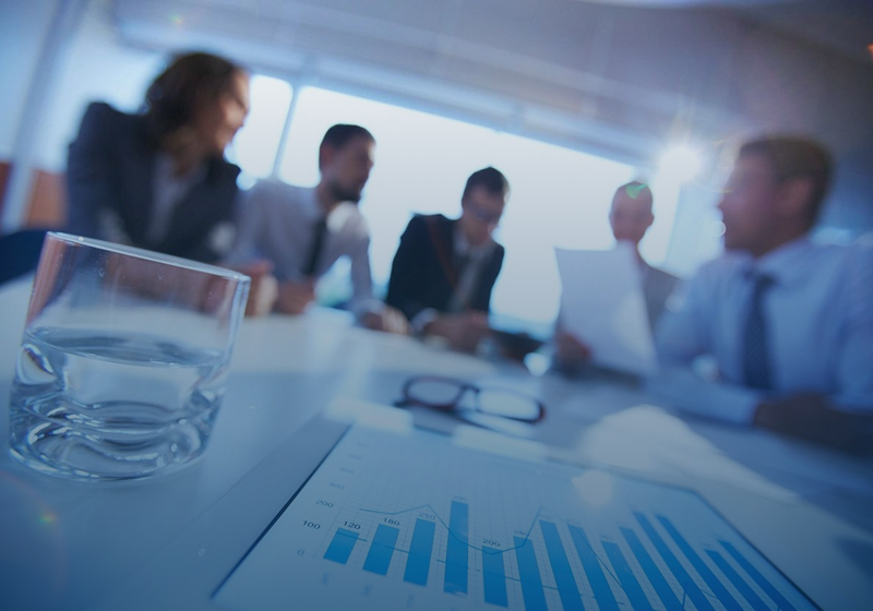 Business team discussing charts and graphs in a meeting.
