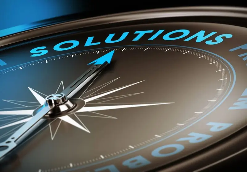 Compass pointing to the word 'SOLUTION' symbolizing direction and answers.