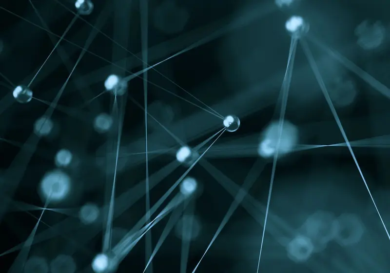 Abstract network of glowing interconnected nodes on a dark background.