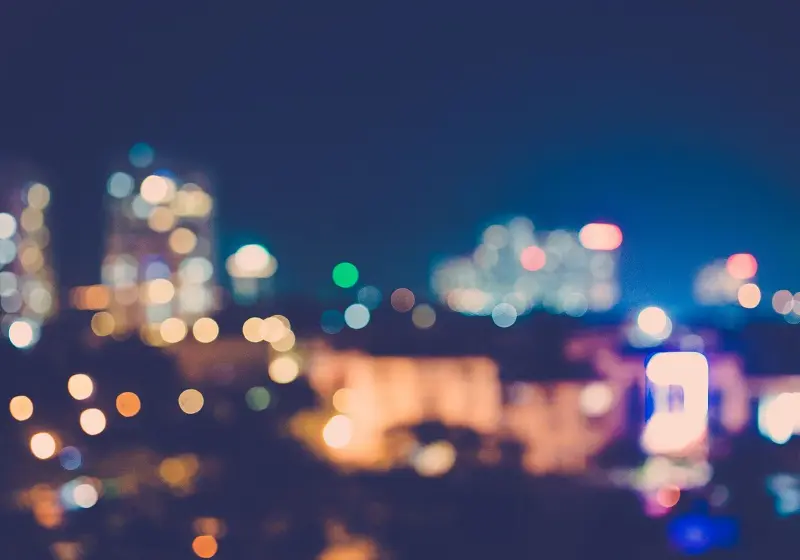 Blurred city lights creating a colorful bokeh effect at night.