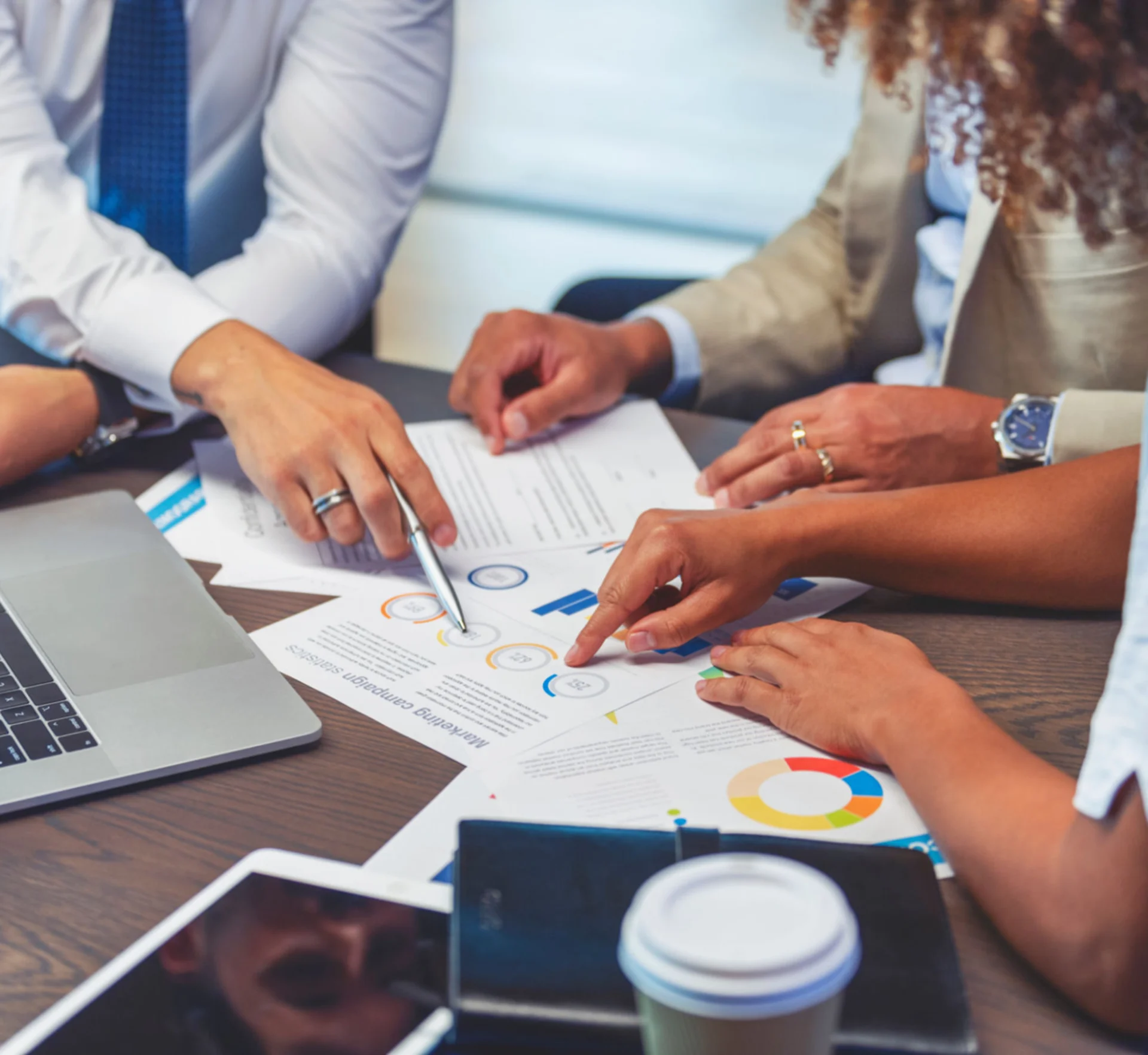 Hands pointing at business documents